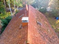 Inspection of the red tiled roof of a single-family house, inspection of the condition of the tiles on the roof of a detached Royalty Free Stock Photo