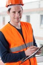 Inspector with clipboard at building site