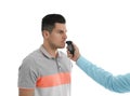 Inspector conducting alcohol breathe testing, man blowing into breathalyzer on white Royalty Free Stock Photo
