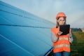 Inspector Engineer Woman Holding Digital Tablet Working in Solar Panels Power Farm  Photovoltaic Cell Park  Green Energy Concept Royalty Free Stock Photo