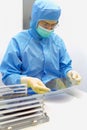 The inspector making incoming check the Silicon Wafers with chips take out from storagebox by hand in gloves in clear