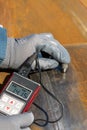 Inspector is measuring thickness of the pipe material from near to weld with a portable ultrasonic wall thickness measurement