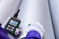 Inspector measuring thickness the pipe with UTM (Ultrasonic thickness measurement