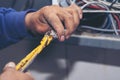 Inspector men hands working switchboard machinery maintenance service. Electrical mechanic technician check wire electric cabinet Royalty Free Stock Photo