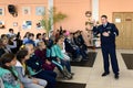 The inspector of the road patrol service of the police teaches elementary school students the rules of the road