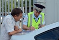 An inspector of the road police patrol service makes a report on the violation of traffic rules. Royalty Free Stock Photo