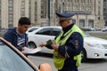 The inspector of traffic police checks the documents of a taxi driver in Central Moscow.