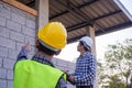 The inspectors are examining the structure of the house and note it in the clipboard to inform engineers to fix before selling to Royalty Free Stock Photo