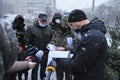 Inspectors from State Ecological Inspection of Ukraine talking to Christmas trees seller checking his papers for permission for