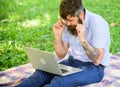 Inspiration for blogging. Looking for inspiration. Man bearded with laptop sit meadow nature background. Blogger