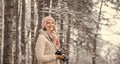 Inspiration create something special. Girl with vintage camera in snowy nature. Traveling concept. Capturing winter