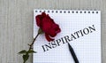 INSPIRATION - words on a white sheet of paper with a red rose on a gray background Royalty Free Stock Photo