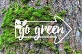 Inspirational banner Go Green banner decorated hand drawn leave, index on the green moss tree bark background Royalty Free Stock Photo