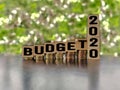 inspirational and conceptual - budget 2020 on wooden blocks with coins stack background Royalty Free Stock Photo