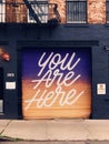 Inspirational garage door mural in Brooklyn, NY with gradient background.