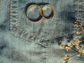 inspirational image of couple's rings with denim jeans colour background