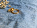 inspirational image of couple's rings with denim jeans colour in vintage background