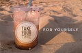 inspirational motivation words - Take your time for yourself . Cup of ice coffee and the beach sand. Royalty Free Stock Photo