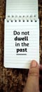 Inspirational and motivational concept. 'Do not dwell in the past' with vintage background.