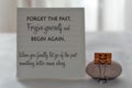 Message on notepaper - Forget the past. Forgive yourself and begin again. When you freely let go of the past something beter comes