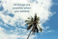 Inspirational motivational quote- All things are possible when you believe. With single palm tree on bright blue sky background. Royalty Free Stock Photo