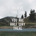 Inspirational motivational quote `Believe you can & you are half way there.` with mountain view background. Royalty Free Stock Photo