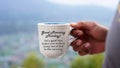 Inspirational motivational quote on coffee cup in hand - Good morning Monday . Set a goal that make you want to jump out of bed