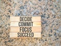 Inspirational motivational quote - decide commit focus succeed on wooden blocks Royalty Free Stock Photo