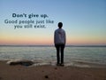 Inspirational motivational quote - Do not give up. Good people just like you still exist. With blurry image of young man standing Royalty Free Stock Photo