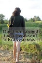 Inspirational motivational quote - Do not ruin a good today because of a bad yesterday. With young woman walking on field Royalty Free Stock Photo