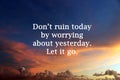 Inspirational motivational quote- do not ruin today by worrying about yesterday. Let it go. With colorful sunset sky background.
