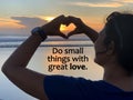 Inspirational motivational quote - Do small things with great love. With woman making love heart sign gesture against the sunset Royalty Free Stock Photo