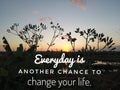 Inspirational motivational quote- everyday is another chance to change your life. With meadow grass flowers silhouette and sunset