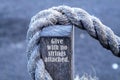 Inspirational motivational quote - Give with no strings attached. With natural rope on a wood in gray tone color background.