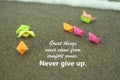 Inspirational motivational quote - Great things never come from comfort zones. With group of colorful origami paper boats.