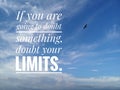 Inspirational motivational quote - If you are going to doubt something, doubt your limits.  With background of bright blue sky. Royalty Free Stock Photo