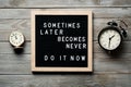 Inspirational motivational quote Sometimes later becomes never. Do it now words on a letter board on wooden background near