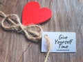 Inspirational motivational quote "give yourself time" text on white paper background.