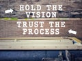 Inspirational Motivational quote "Hold the vision, trust the process" in vintage background. Stock photo.