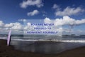 Inspirational motivational quote- You are never too old to reinvent yourself. With blurry image of a young surfer girl standing Royalty Free Stock Photo