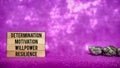 inspirational and motivational text of determination motivation willpower resilience on wooden blocks with purple background