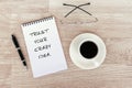 Motivational - Trust your crazy idea text on note pad on top of wood desk