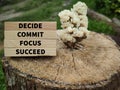 Inspirational and motivational words of decide commit focus succeed on wooden blocks in vintage background