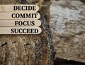 Inspirational and motivational words of decide commit focus succeed on wooden sticks