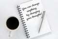 Inspirational motivational words - You can change anything, by changing your thoughts. On book with pen, morning coffee on white. Royalty Free Stock Photo