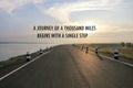 Inspirational positive quote `A journey of a thousand miles begins with a single step` on a road and water reservior background.