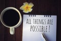 Inspirational quote - All things are possible. A writing note on white paper book, with a cup of morning coffee, flower and a pen. Royalty Free Stock Photo