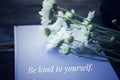 Inspirational quote - Be kind to yourself. Self love and care concept. On vintage background of white daisy flowers bouquet. Royalty Free Stock Photo