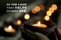 Inspirational quote - Be the light that helps others see. Be inspire and kindness concept with person holding a candle light.