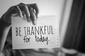 Inspirational quote - Be thankful for today. With young or boy holding white paper book sign with notes reminder.